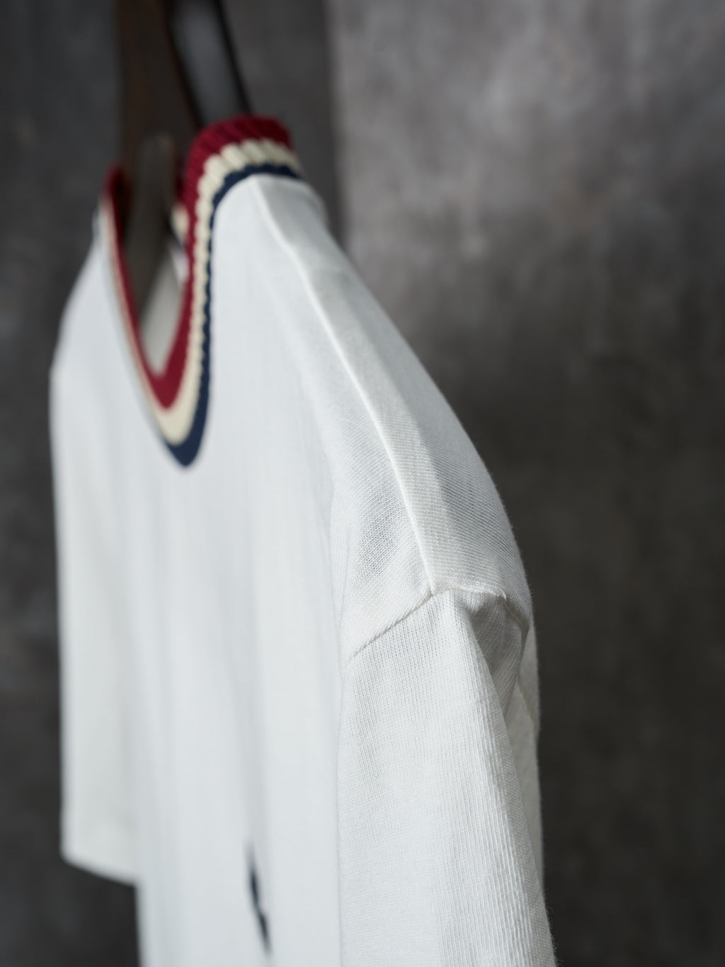 White Moncler T-shirt side view with striped collar detail
