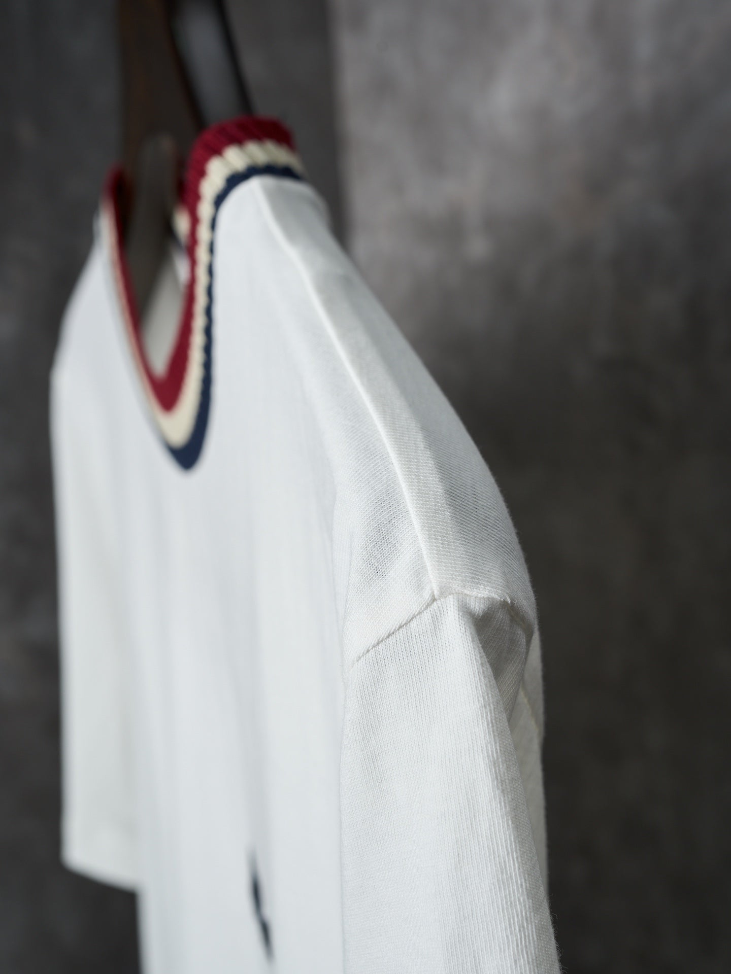 White Moncler T-shirt side view with striped collar detail