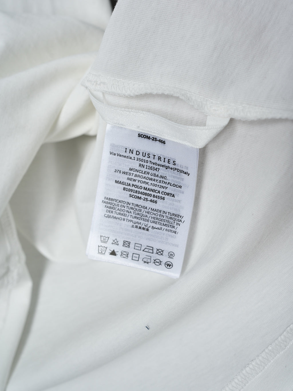 White Moncler T-shirt care label tag on interior