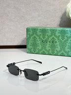 Gucci rectangular sunglasses with dark lenses, black frame, and beaded temple detail
