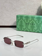 Gucci rectangular sunglasses with burgundy lenses, maroon frame, and beaded temple detail