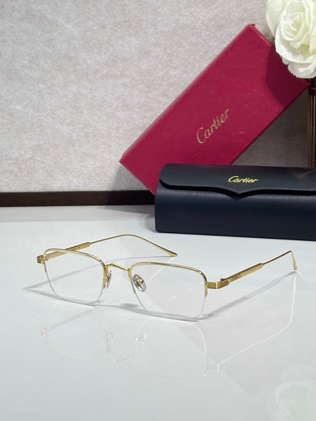Clear-lens eyeglasses with gold metal frames and rectangular shape