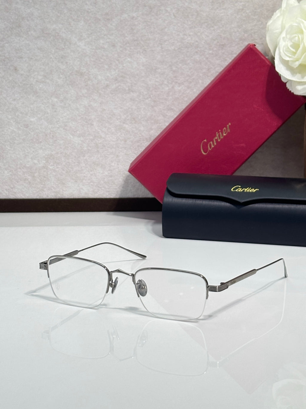 Clear-lens eyeglasses with dark metal frames and rectangular shape
