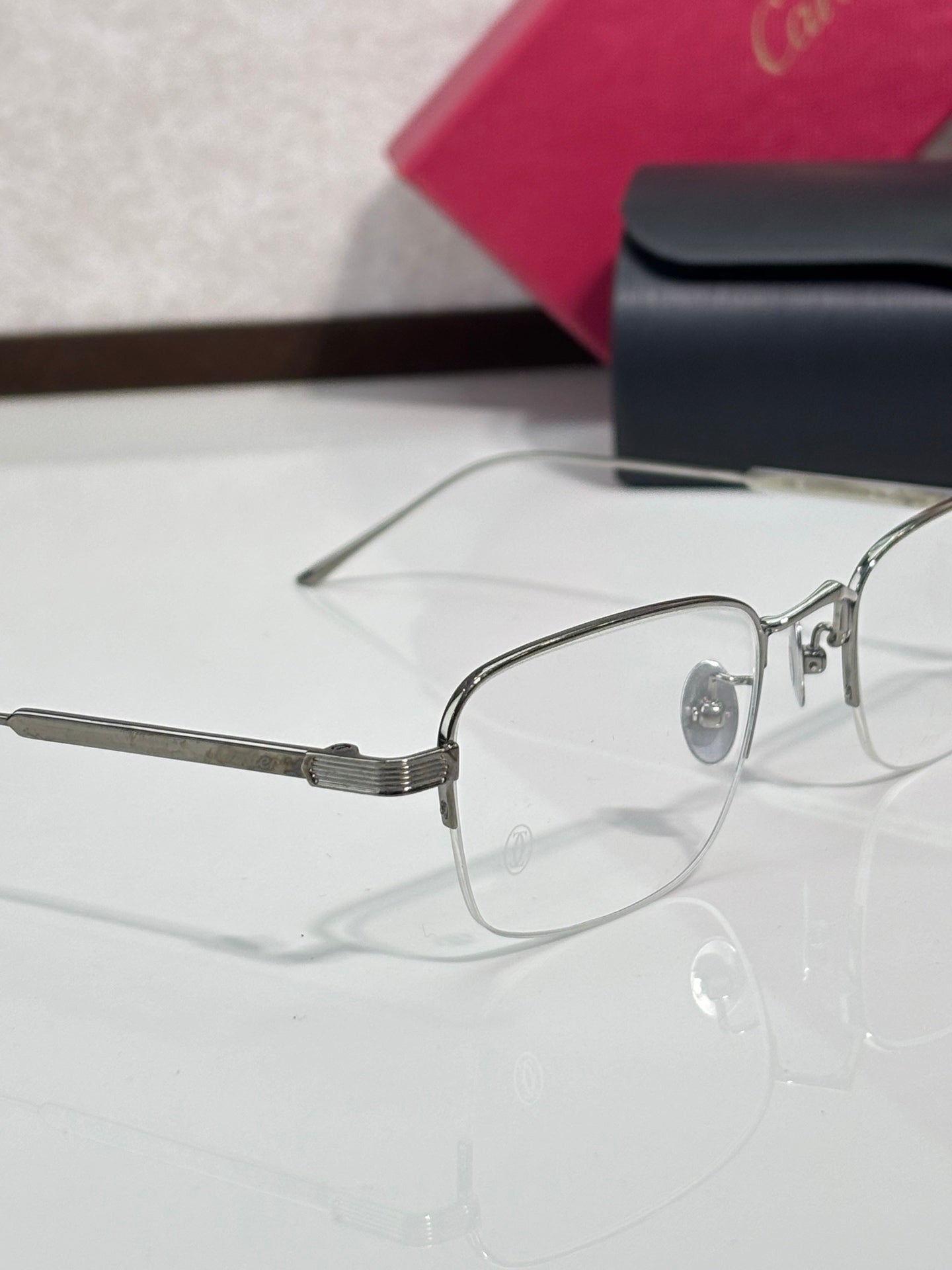 Clear-lens eyeglasses side view with silver metal frame