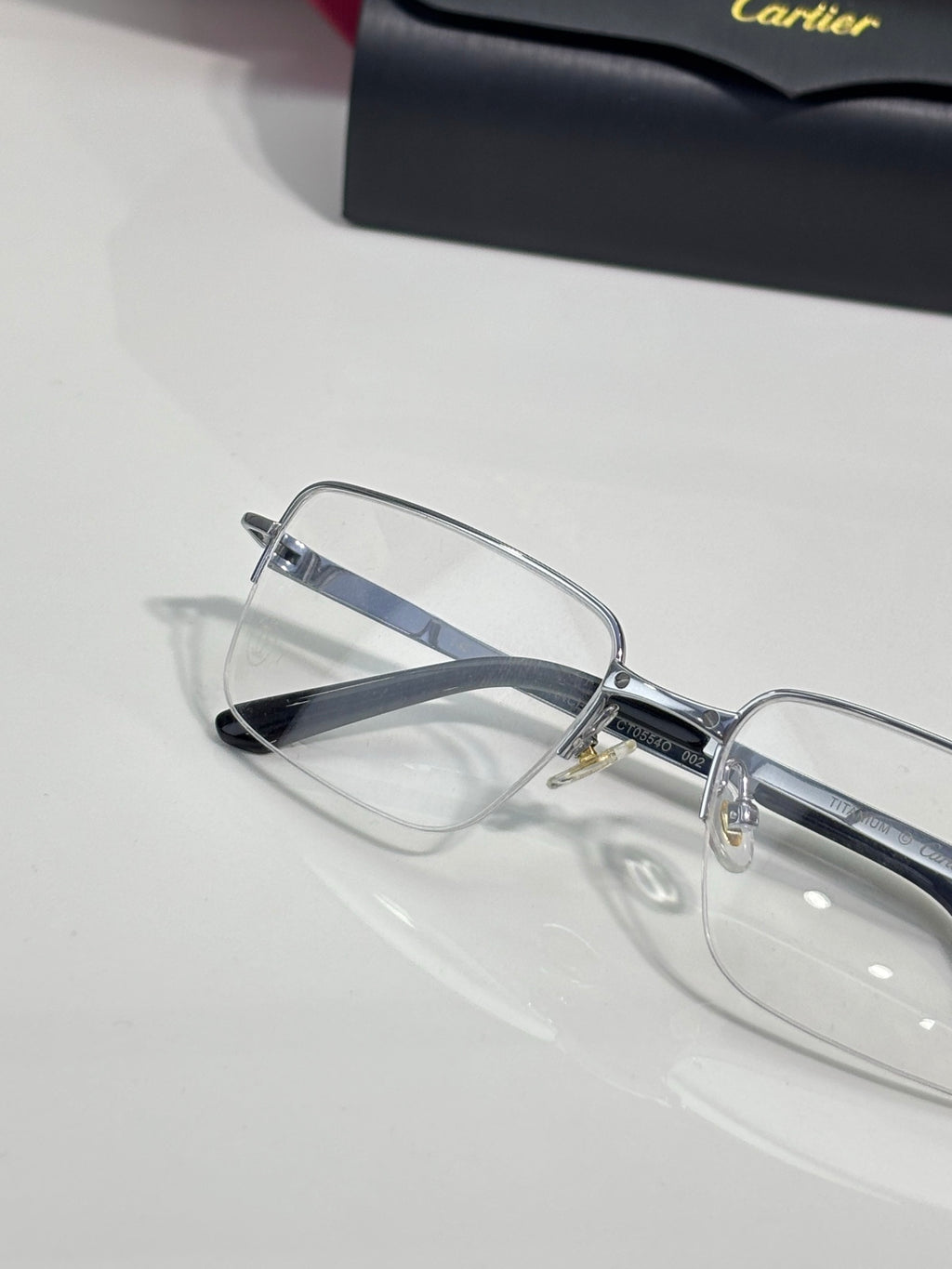 Cartier eyeglasses with clear rectangular lenses and silver-tone frame, side detail