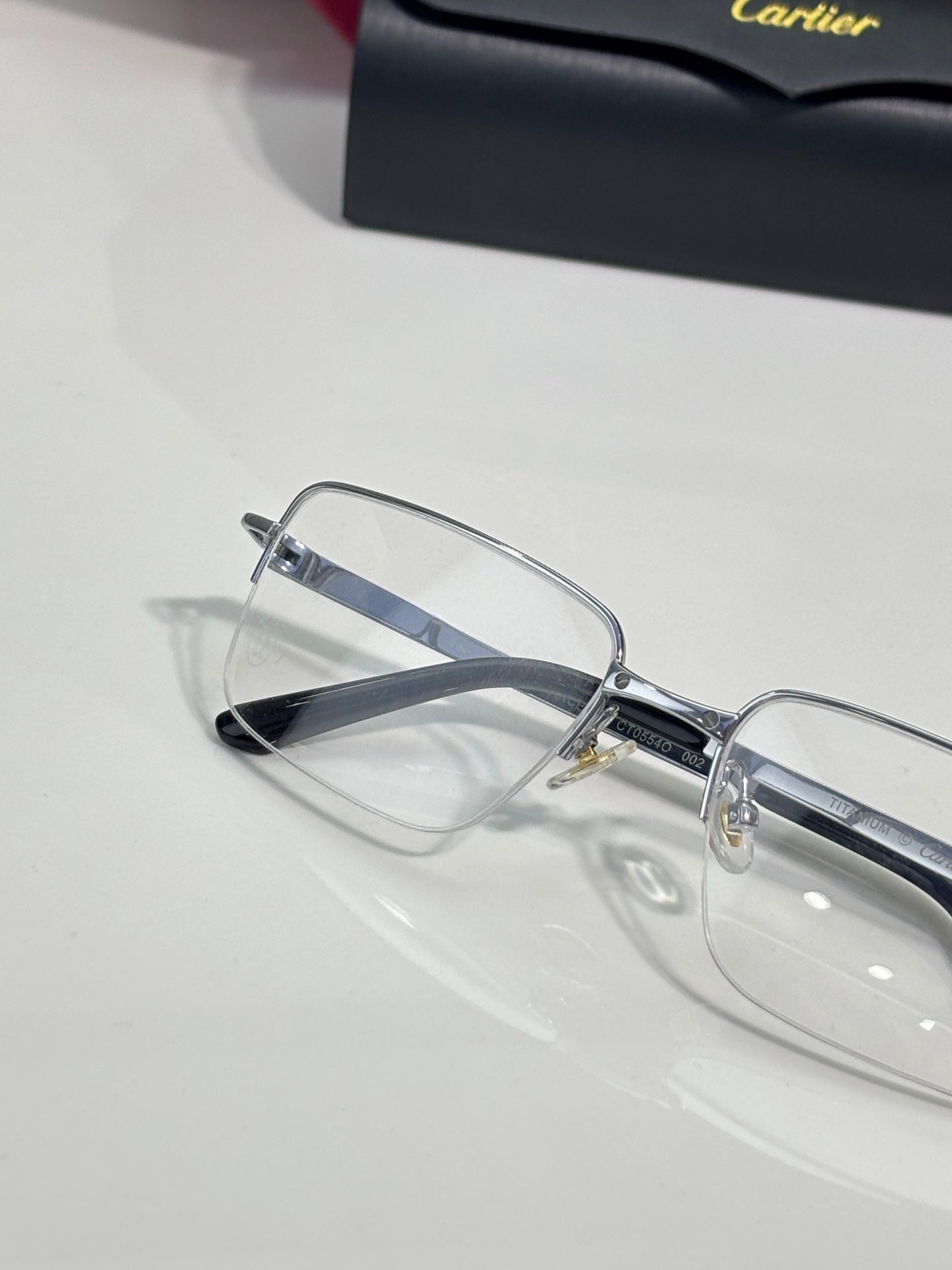 Cartier eyeglasses with clear rectangular lenses and silver-tone frame, side detail