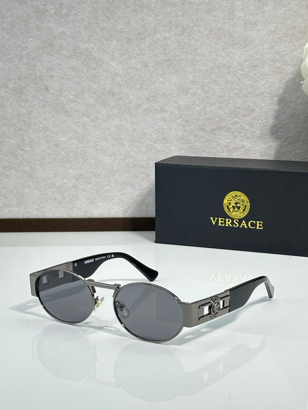 Versace round sunglasses with silver frame and dark gray lenses, black temples