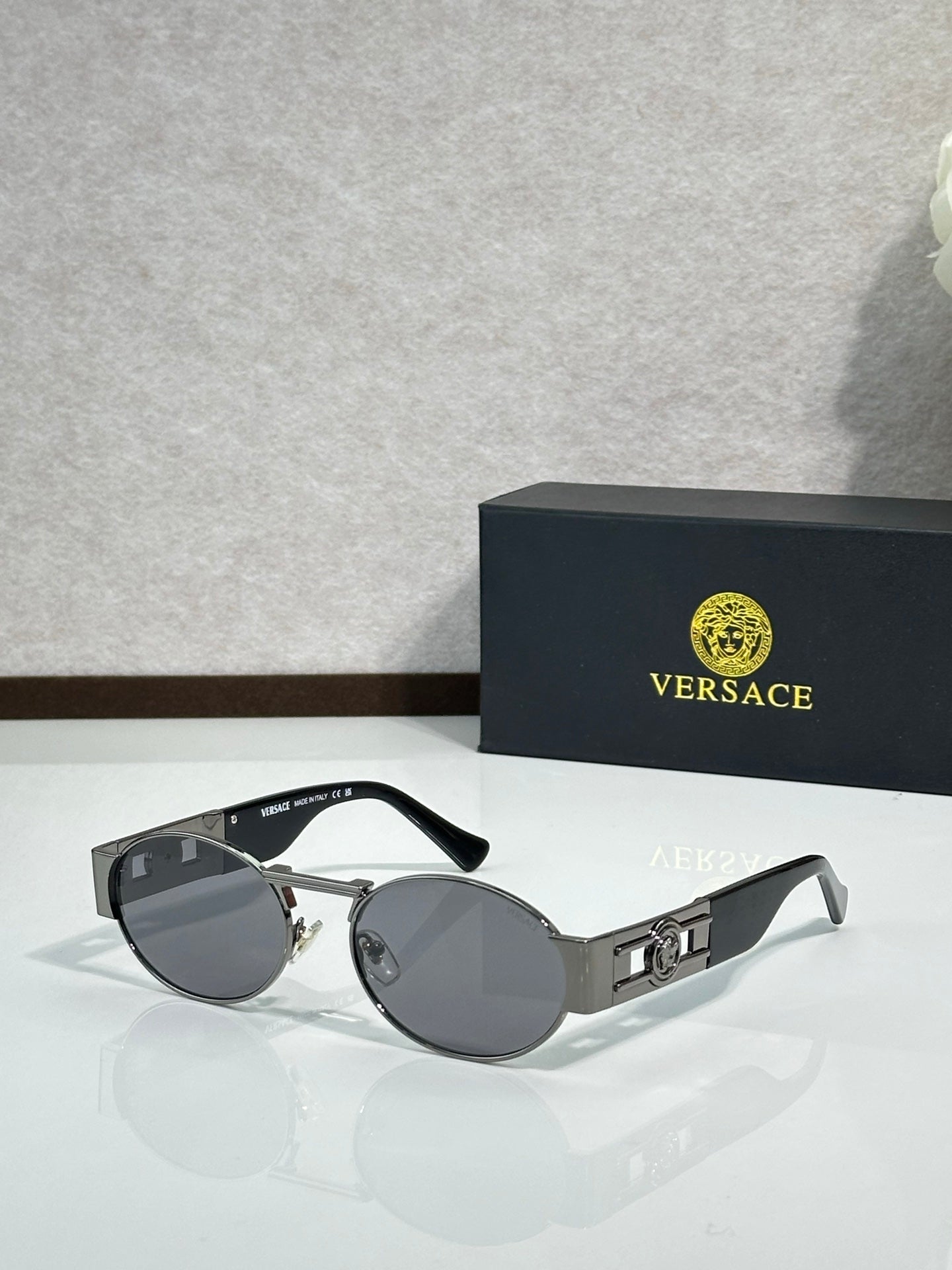 Versace round sunglasses with silver frame and dark gray lenses, black temples