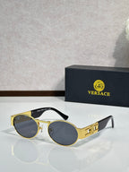 Versace round sunglasses with gold frame and dark lenses, black temple tips