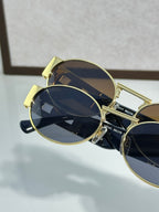 Versace round sunglasses with gold frame and dark blue lenses, side profile view