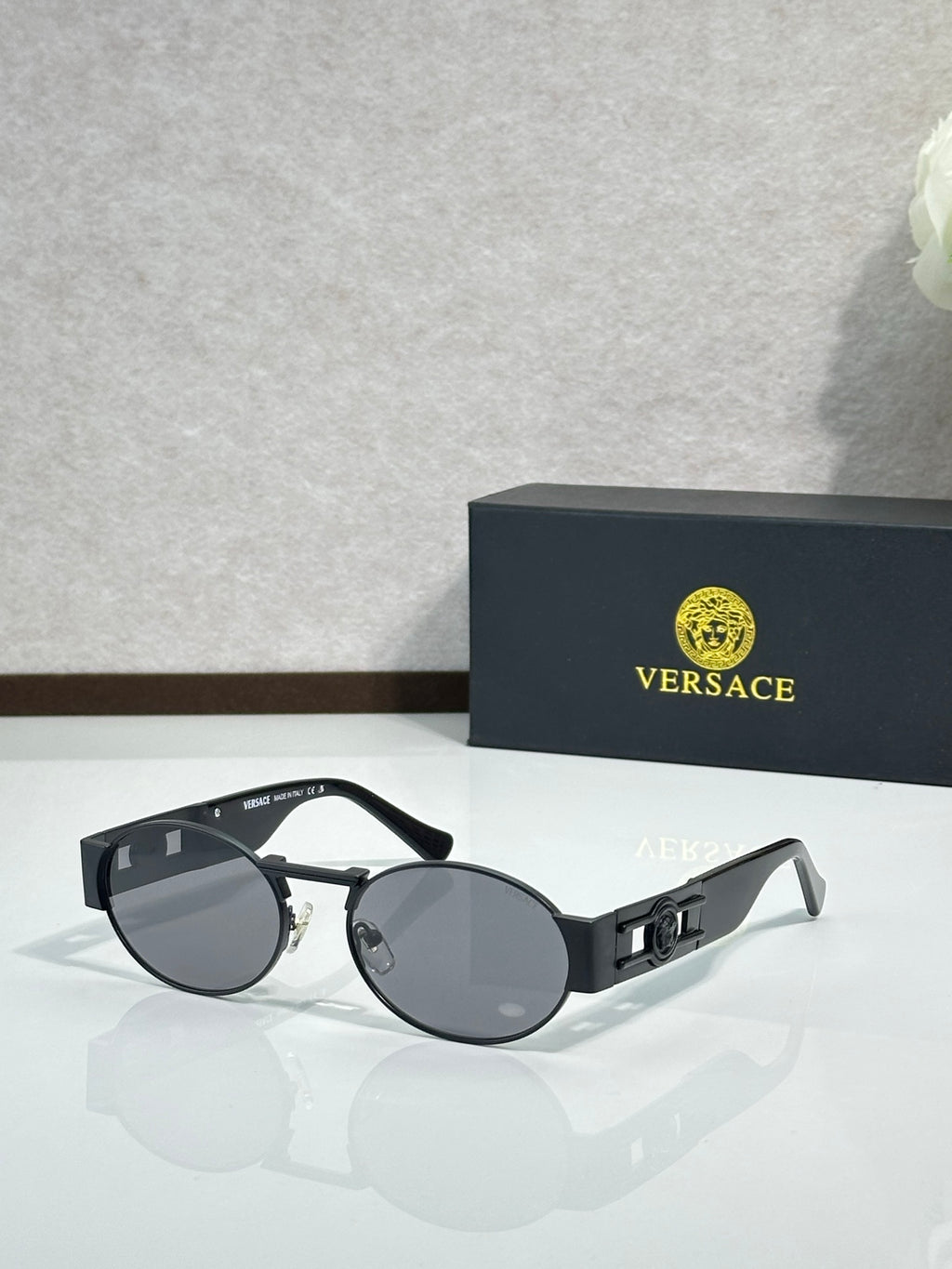 Versace round sunglasses with black frame and dark gray lenses