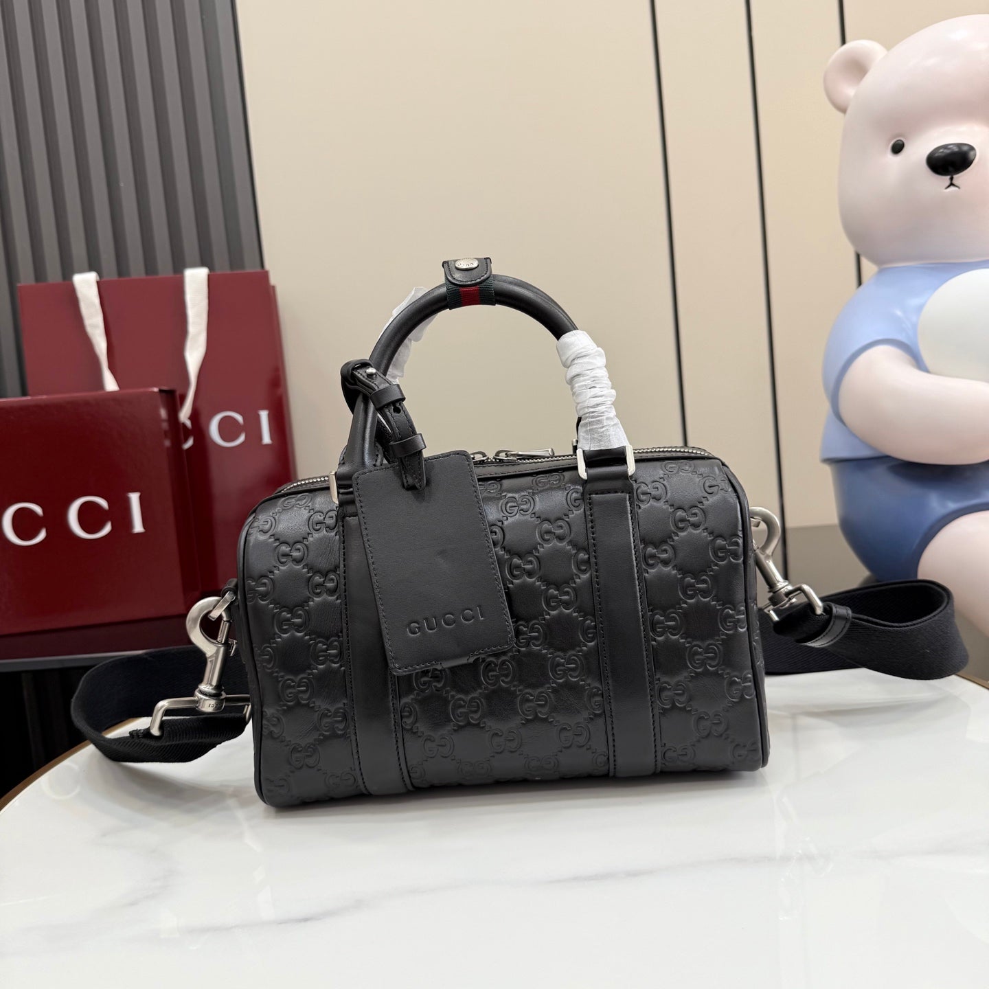 Gucci structured handbag in dark gray with GG monogram embossing and top handles