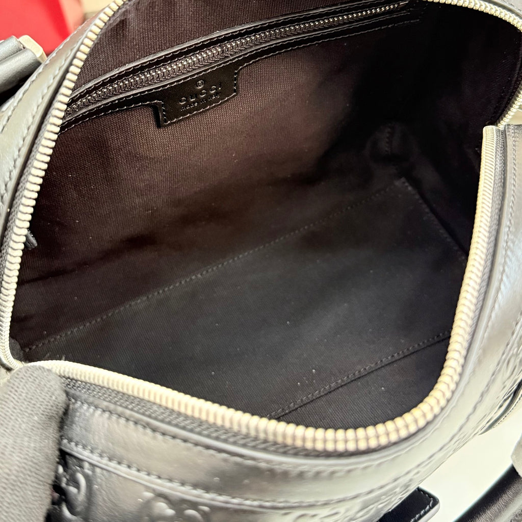 Handbag interior with dark fabric lining and zip opening with textured trim