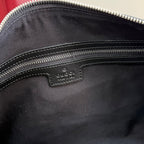 Handbag interior close-up showing small Gucci leather label near zipper