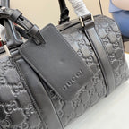 Gucci bag with embossed GG pattern, front flap and top handles