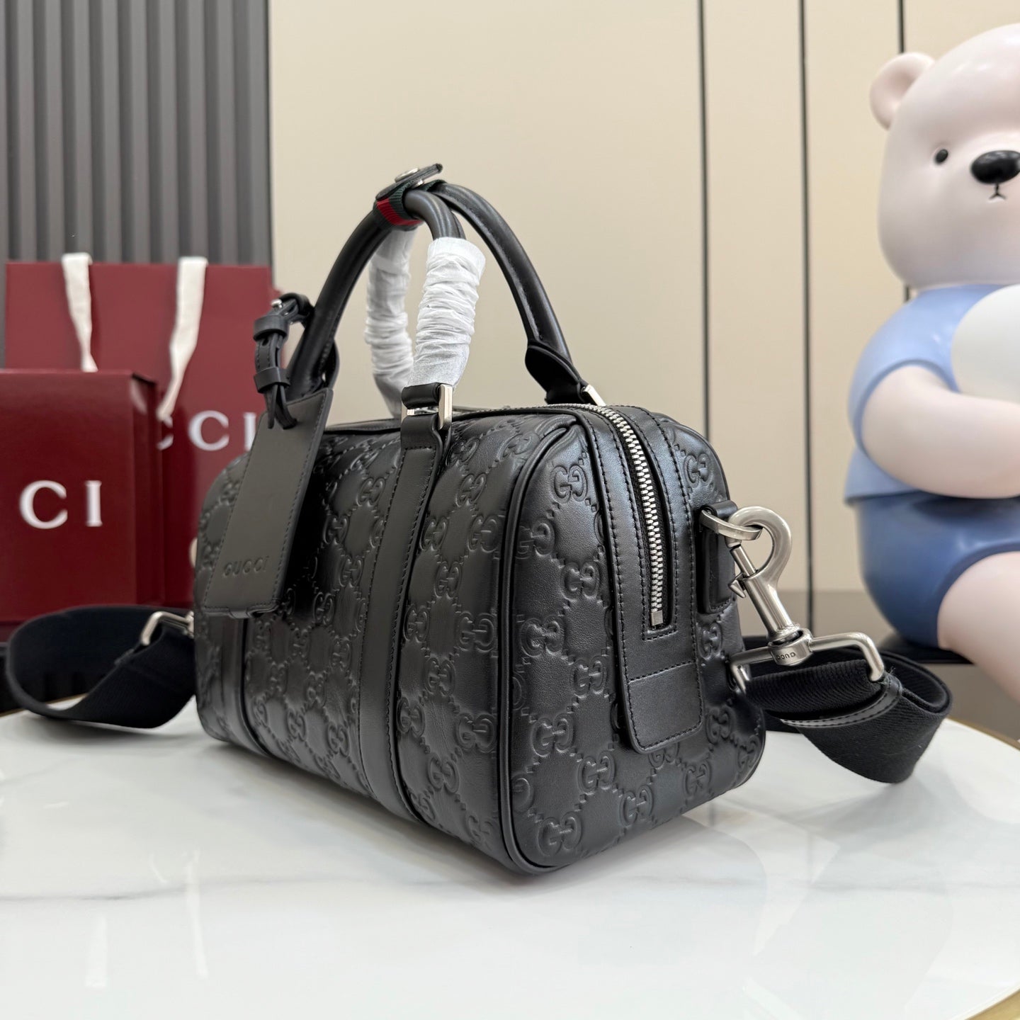 Dark gray GG monogram handbag with zipper front pocket and shoulder strap