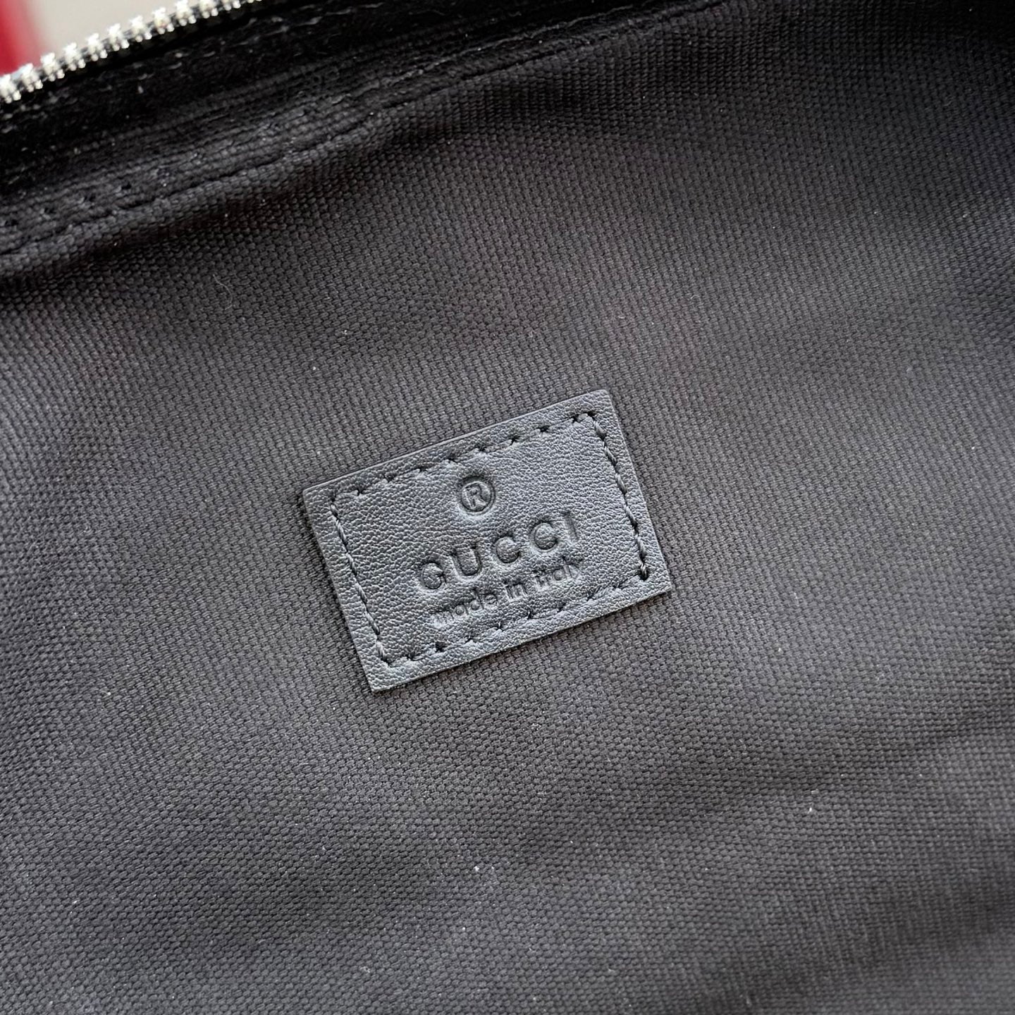 Gucci bag interior label patch on fabric lining, dark gray