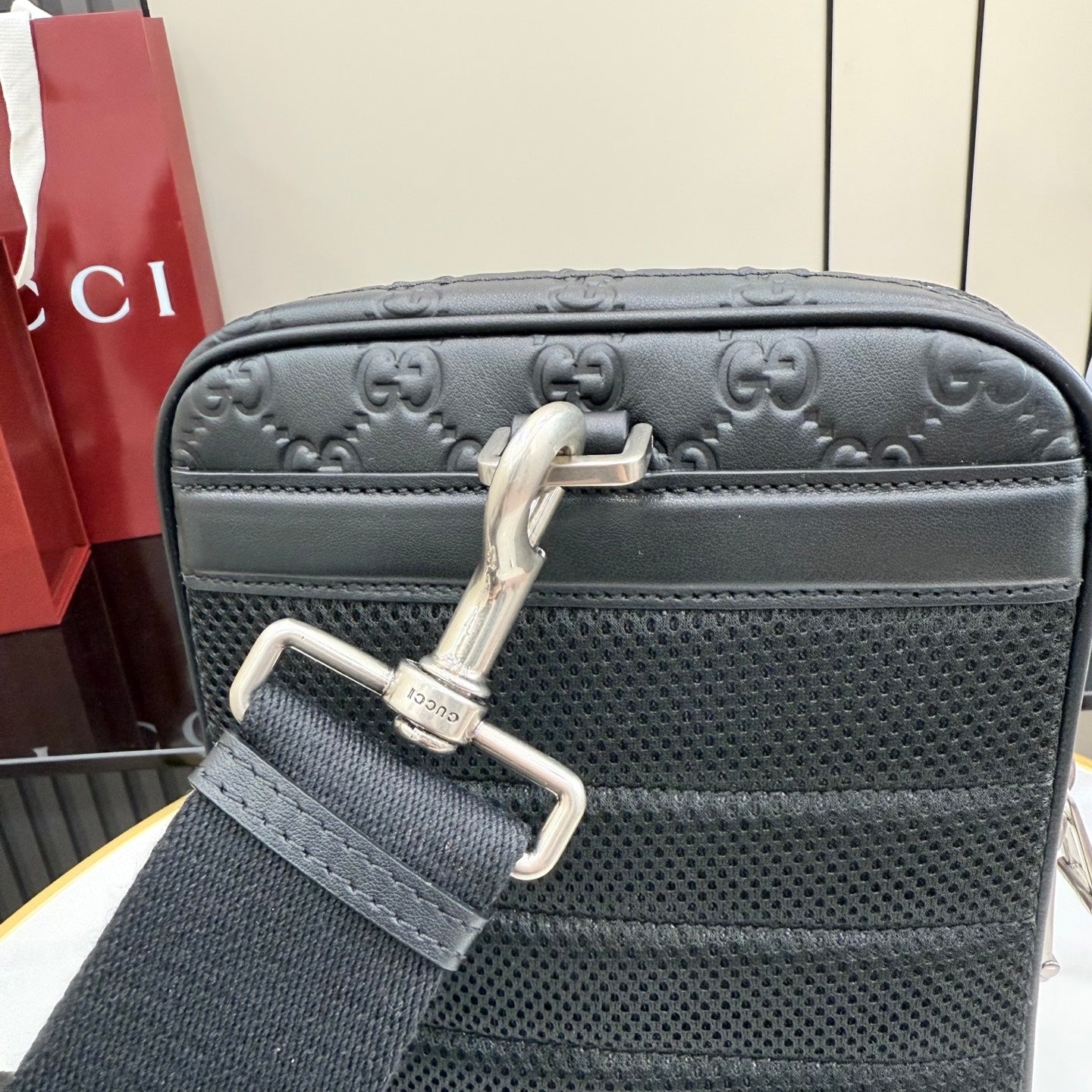 Gucci GG-embossed crossbody bag, dark gray with silver hardware