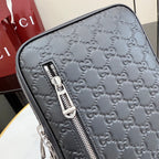 Gucci monogram crossbody bag close-up of zipper and embossed logo pattern