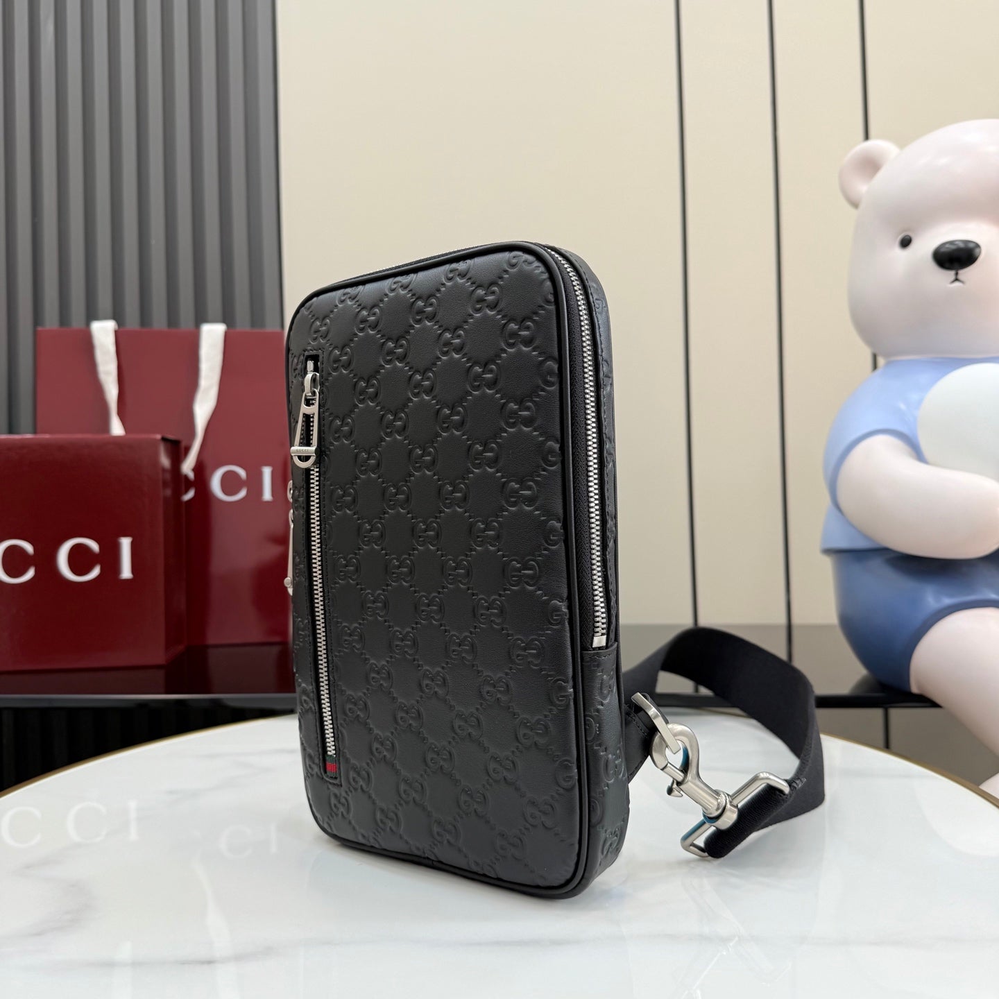 Gucci monogram crossbody bag back view with vertical zip, dark gray/black