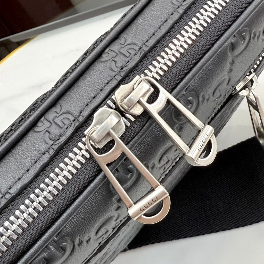 Gucci crossbody bag hardware close-up with silver buckles and zipper