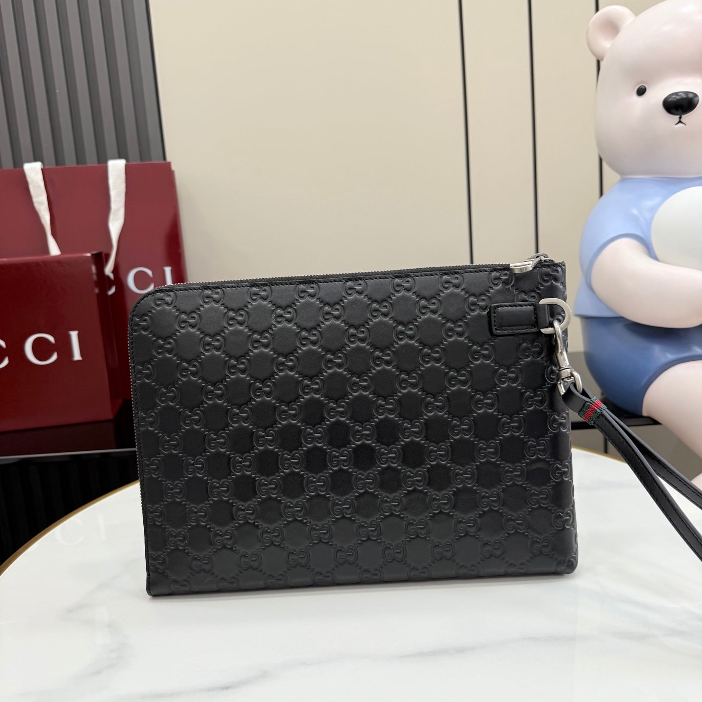 Black Gucci GG-pattern small pouch bag with side buckle and zipper closure