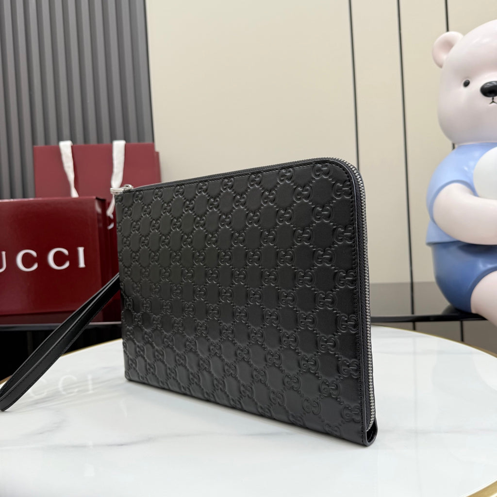 Gucci GG monogram zip pouch bag, dark color with side profile and strap.