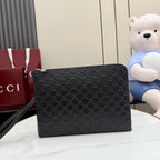Black GG-pattern small Gucci pouch bag with top zipper and front logo detail