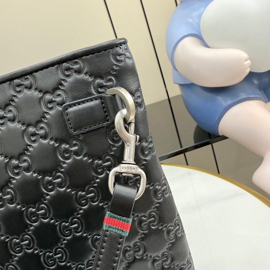 Gucci dark gray GG-embossed bag with metal D-ring and web strap charm