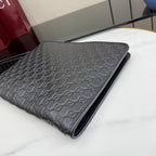 Gucci small bag in dark gray monogram leather, flat clutch style.