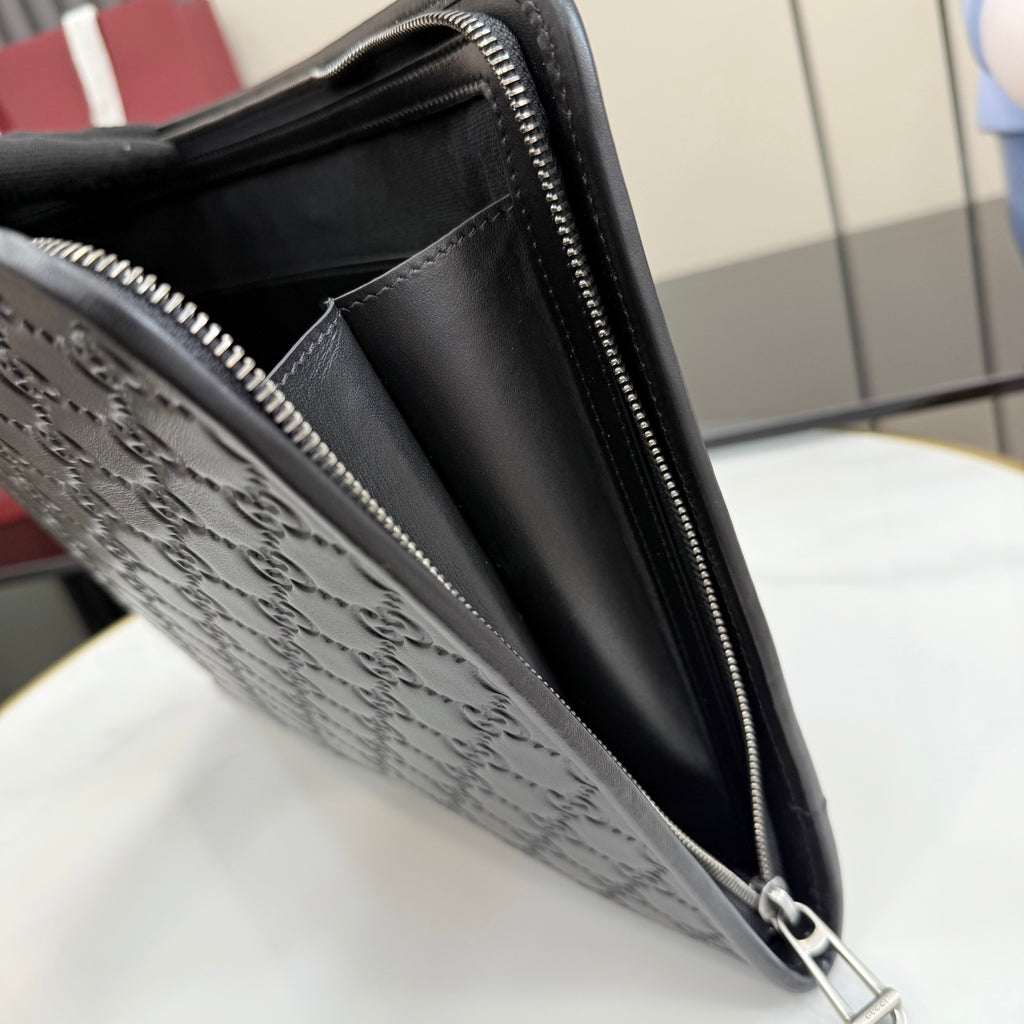 Gucci small bag side view with dark embossed GG texture, zipper, and strap ring.