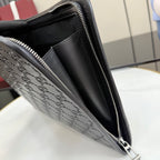 Gucci small bag side view with dark embossed GG texture, zipper, and strap ring.