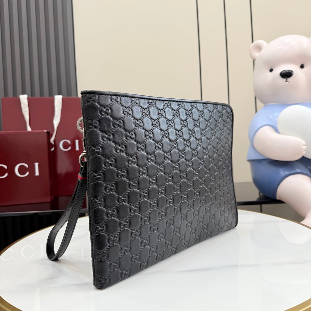 Gucci bag with dark gray monogram print, zip closure, and wrist strap