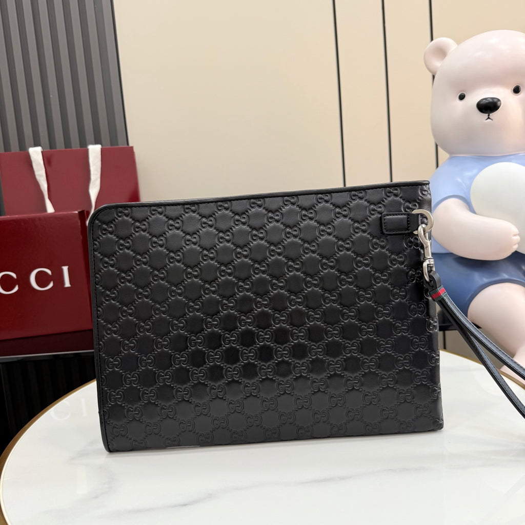 Gucci small bag, dark GG-pattern canvas with flap closure and zipper pull.