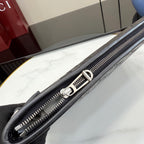 Gucci bag corner detail with silver-toned zipper and black leather trim
