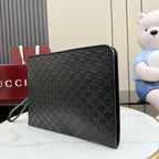 Gucci small bag, dark GG-pattern exterior with corner edging and stitched trim.