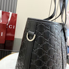 Side view of dark gray monogram tote bag with curved metal D-ring detail