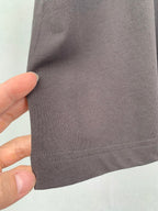 Dark T-shirt side seam and hem stitching close-up