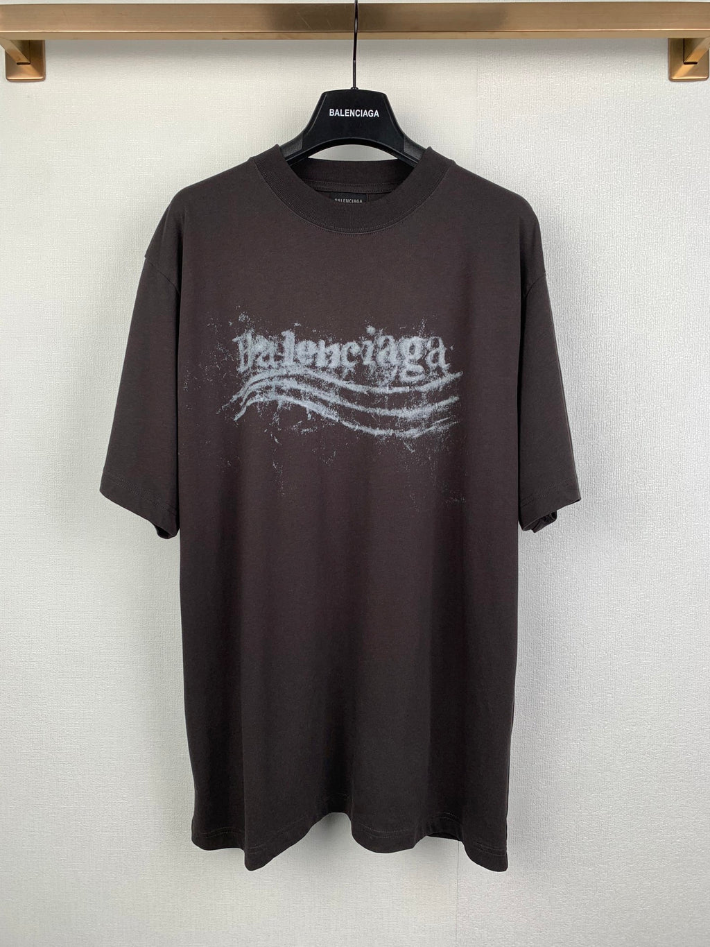Black crew-neck T-shirt with distressed Balenciaga-style logo graphic on front