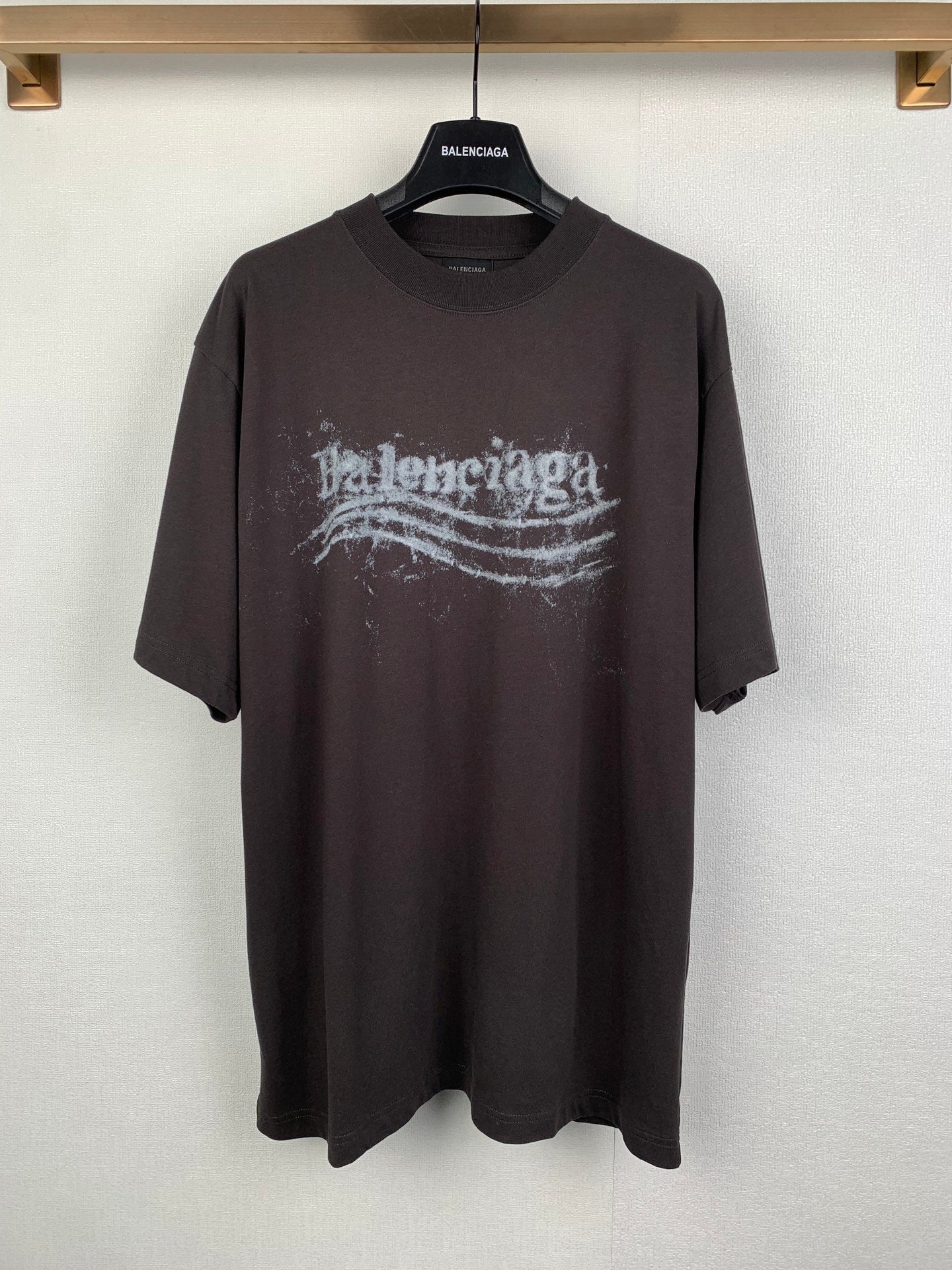 Black crew-neck T-shirt with distressed Balenciaga-style logo graphic on front