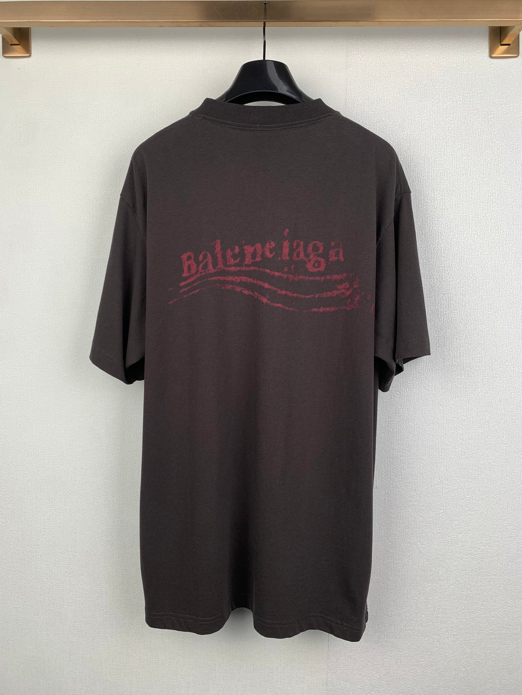 Dark crew-neck T-shirt with red Balenciaga-style logo graphic on back