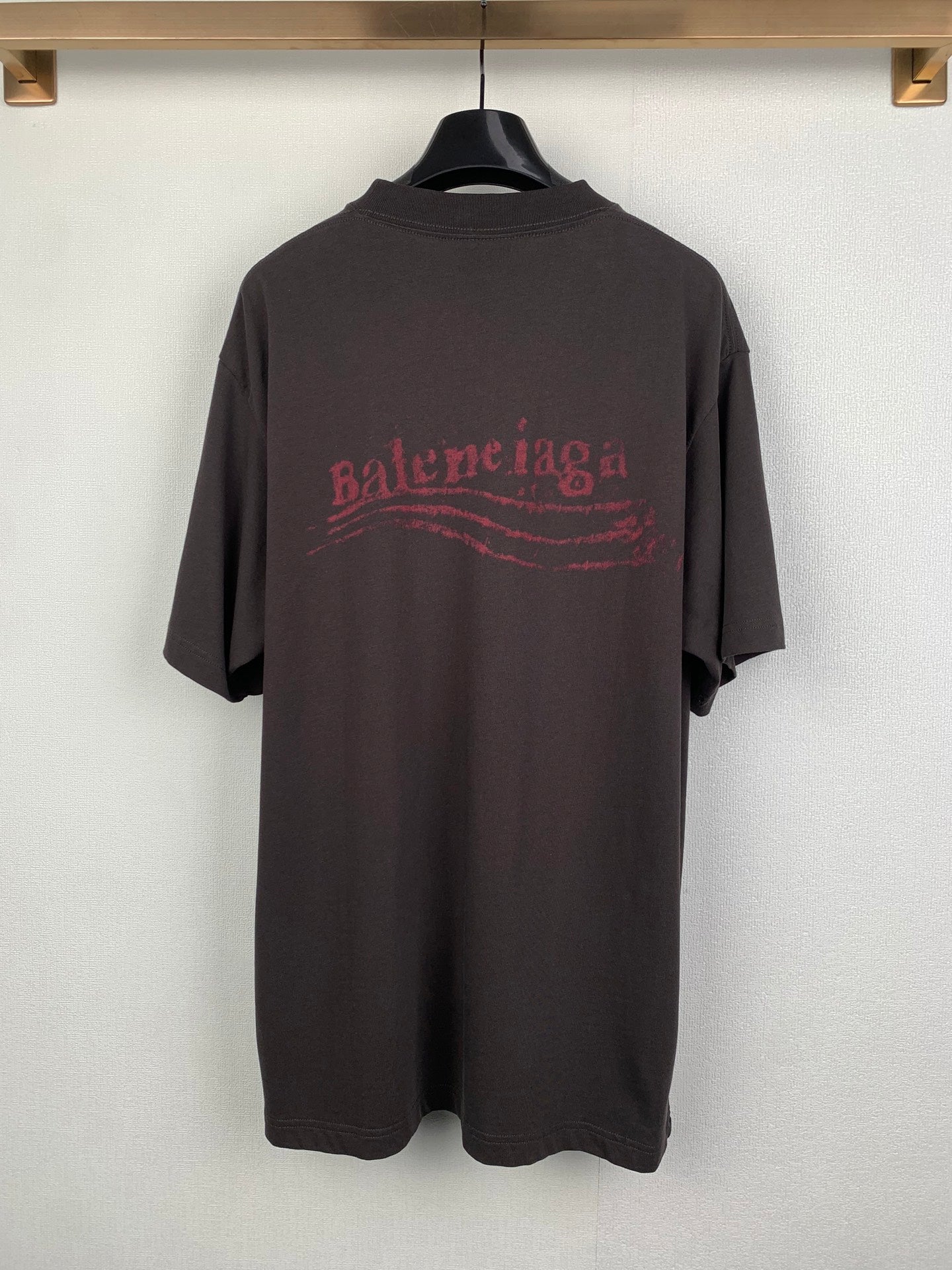 Dark crew-neck T-shirt with red Balenciaga-style logo graphic on back