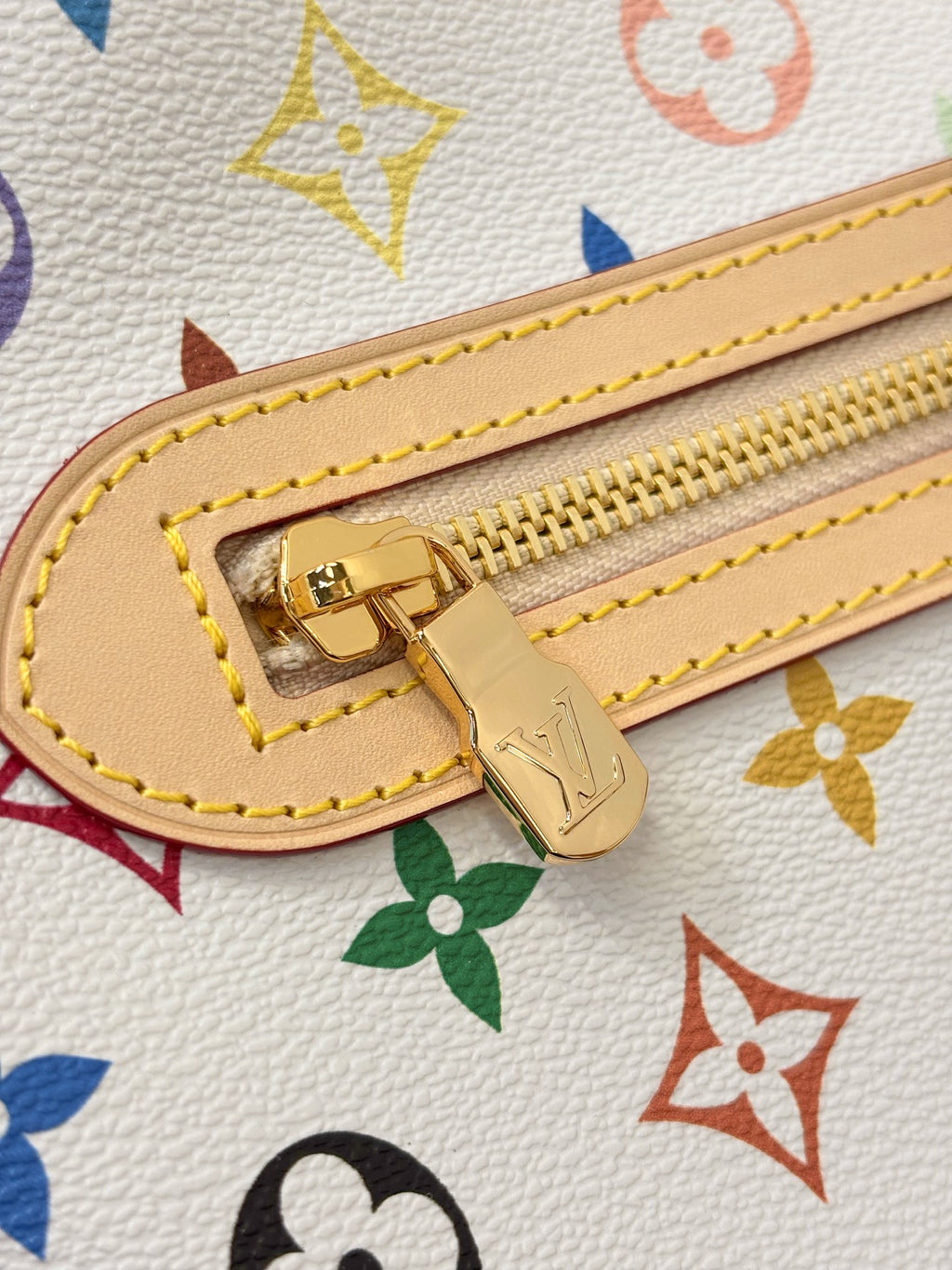 Gold zipper pull on multicolor monogram hobo bag with yellow stitch trim