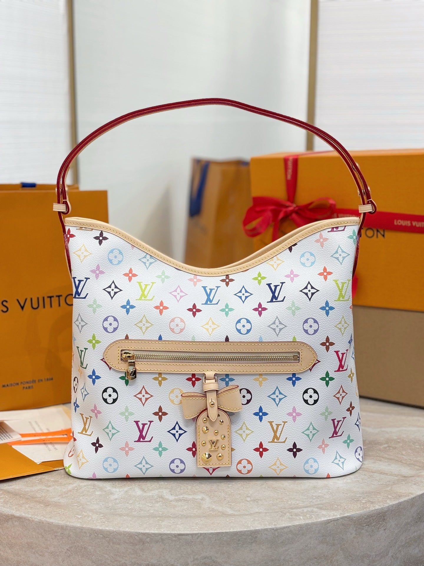 Louis Vuitton hobo bag with multicolor monogram, red handles and top zip front