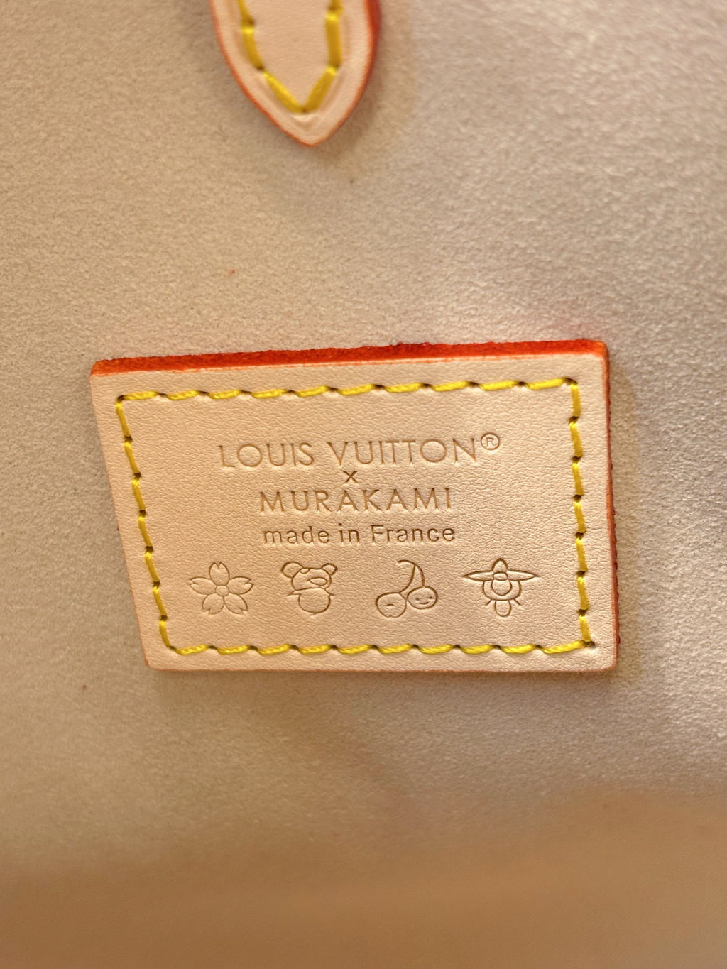 LOUIS VUITTON x MURAKAMI label on multicolor monogram handbag patch
