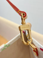 Gold-tone clasp on multicolor monogram bag with red strap loop