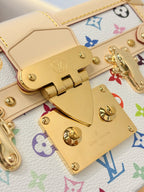 Louis Vuitton bag clasp detail on beige leather with gold hardware over multicolor Monogram canvas