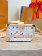 Louis Vuitton mini bag with multicolor Monogram print, beige flap and gold hardware