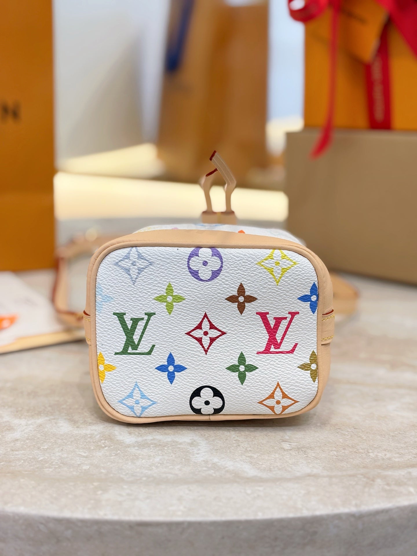 Louis Vuitton crossbody bag with multicolor monogram print and top clasp closure