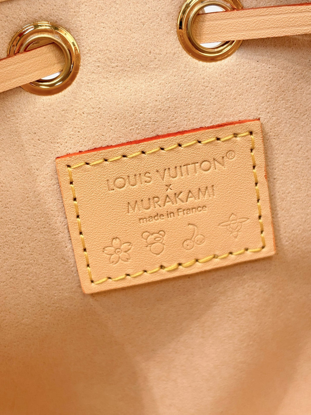 Louis Vuitton bag close-up leather label with “Made in France” and floral detail